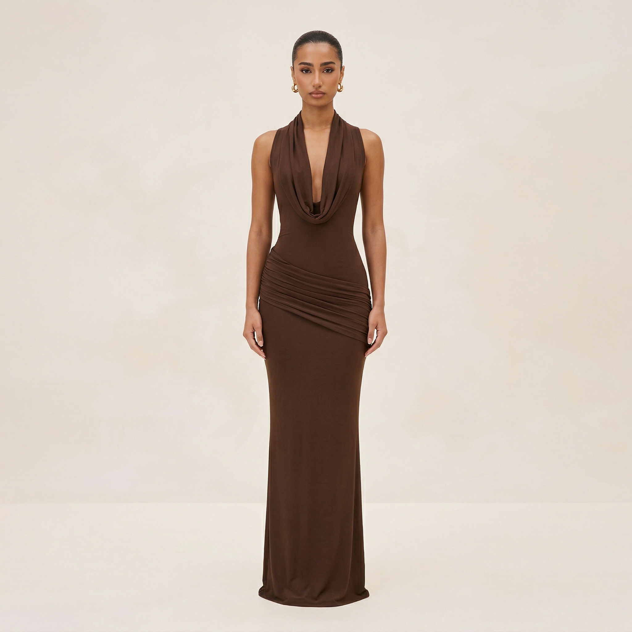 Woman wearing a brown evening gown on a beige background
