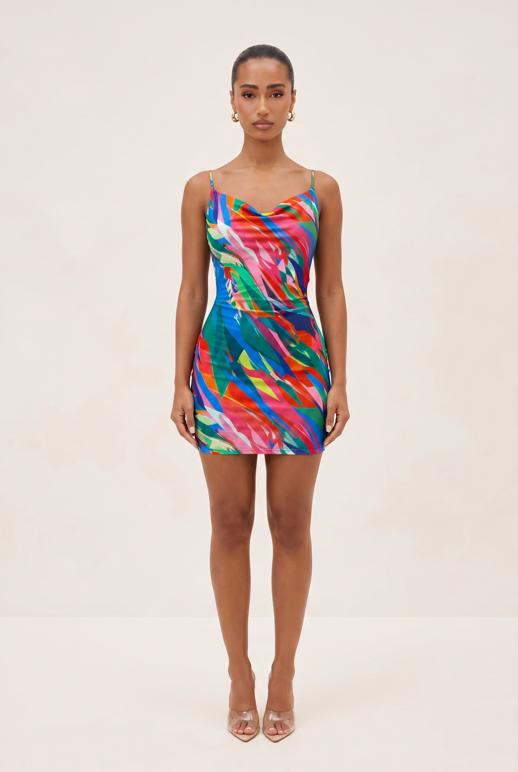 Woman wearing a colorful dress on a plain background
