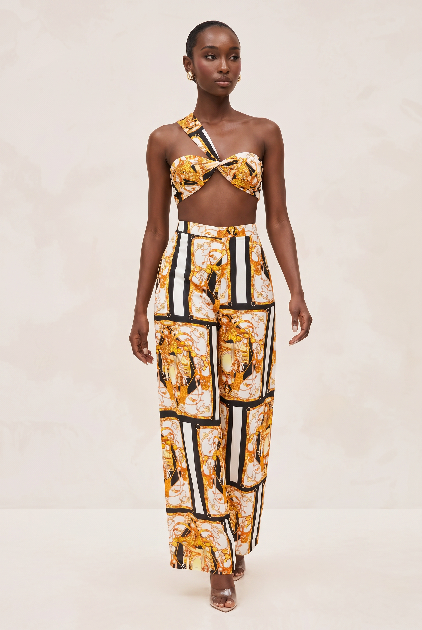 Model wearing a patterned outfit with a white background