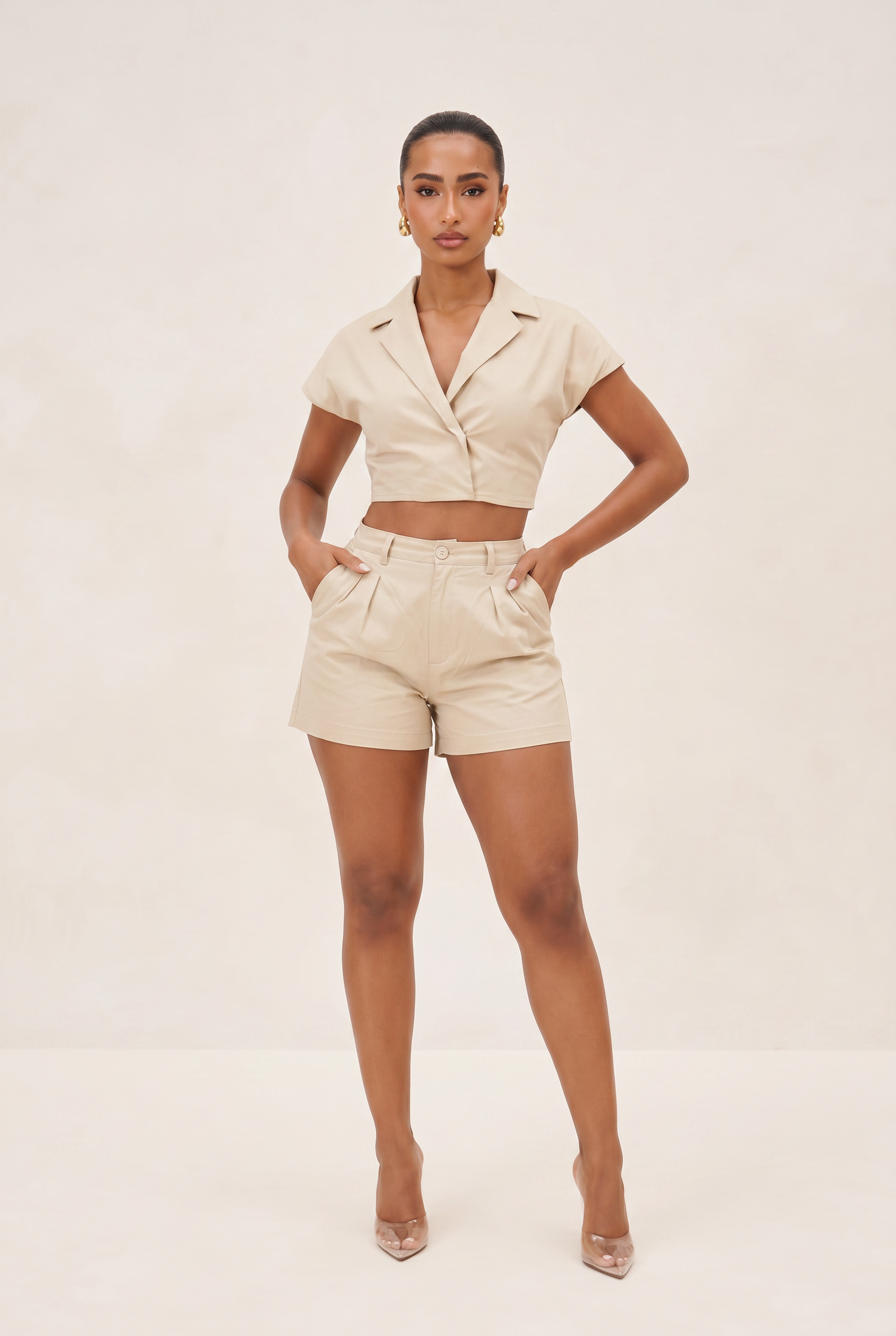 Woman wearing a beige suit with a white background