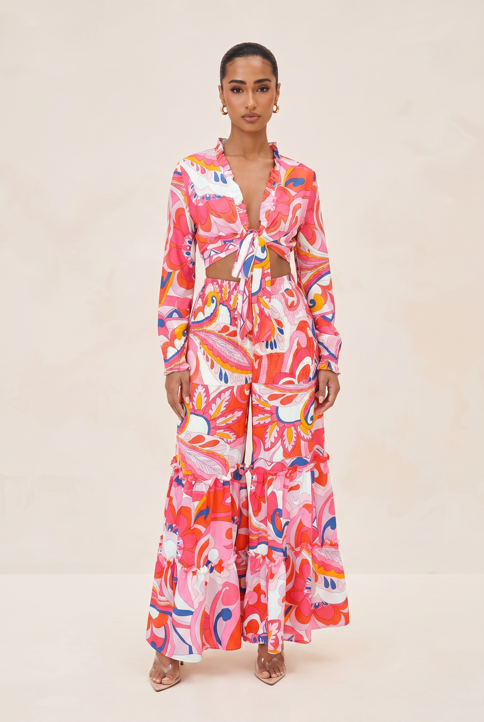 Woman wearing a colorful floral dress on a beige background