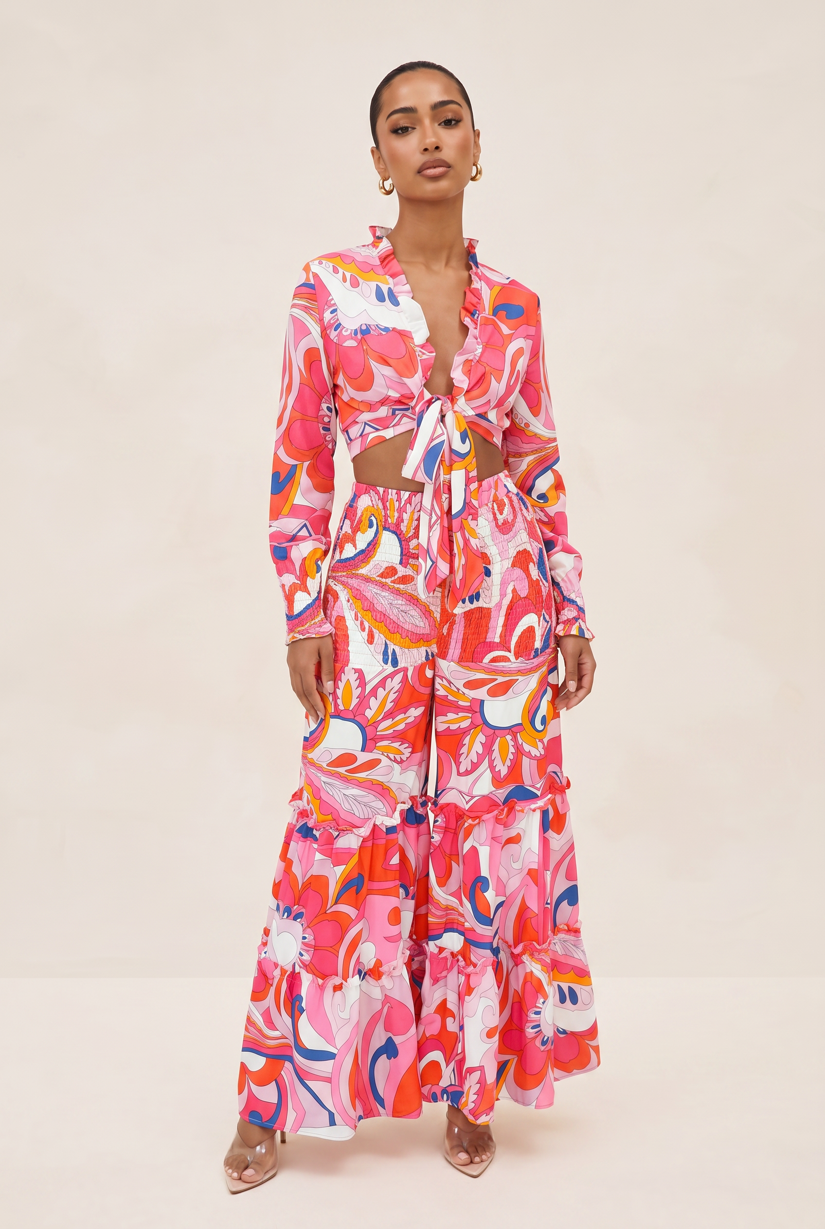Woman wearing a colorful patterned outfit on a beige background