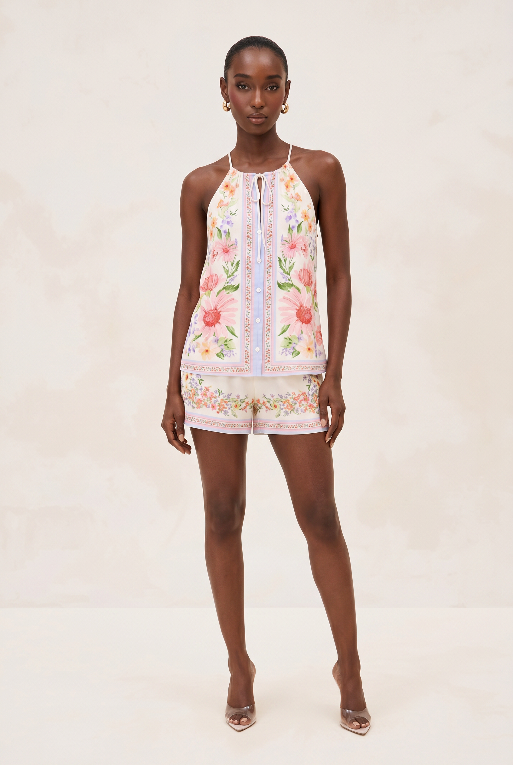 Woman wearing a floral embroidered outfit on a plain background