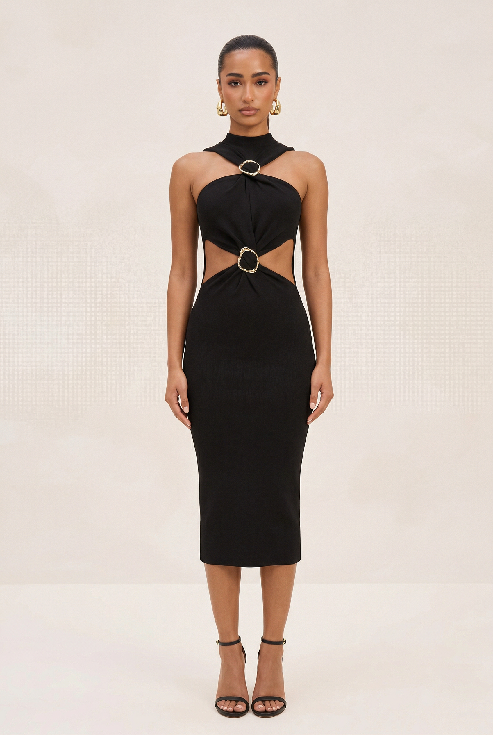Black dress with cut-out design on a white background