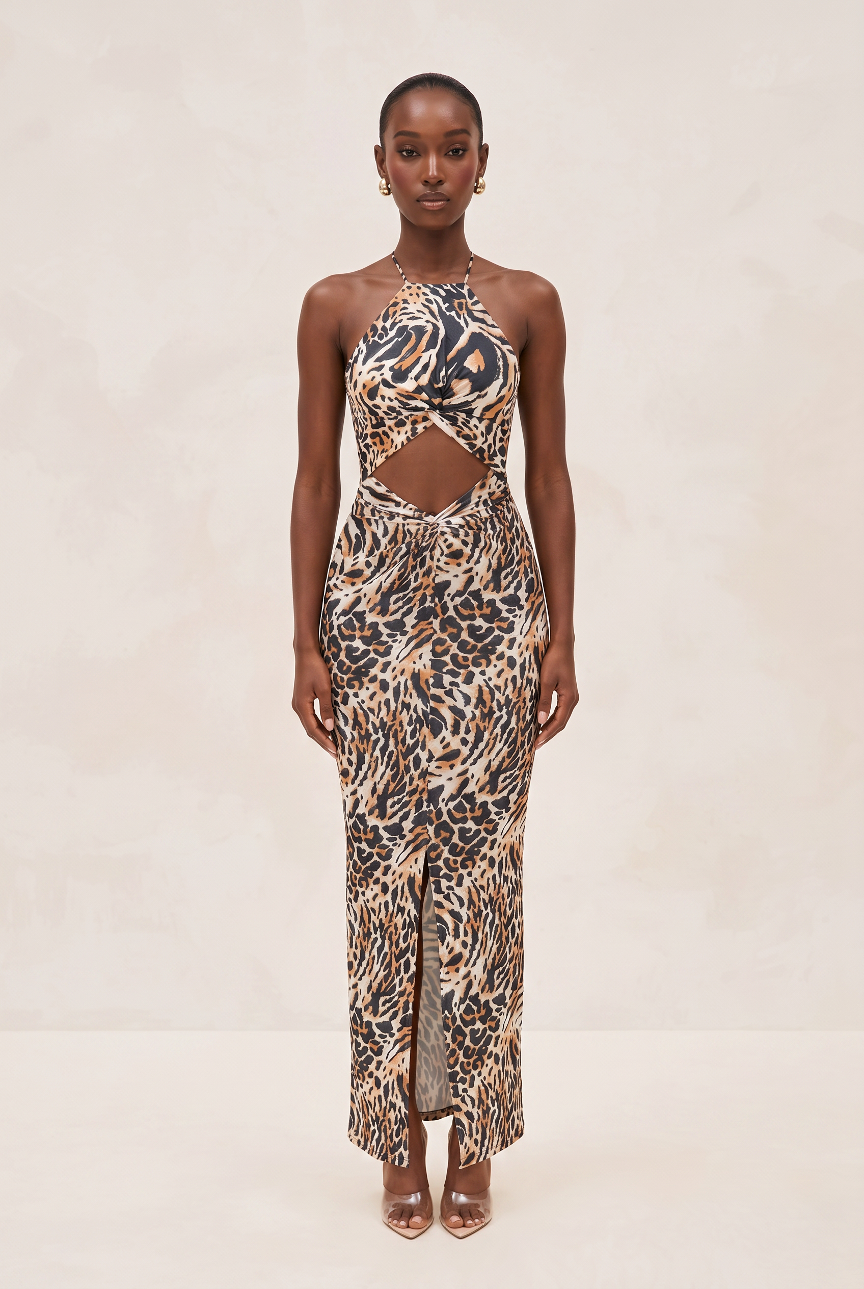 Woman wearing a leopard print halter neck dress on a beige background