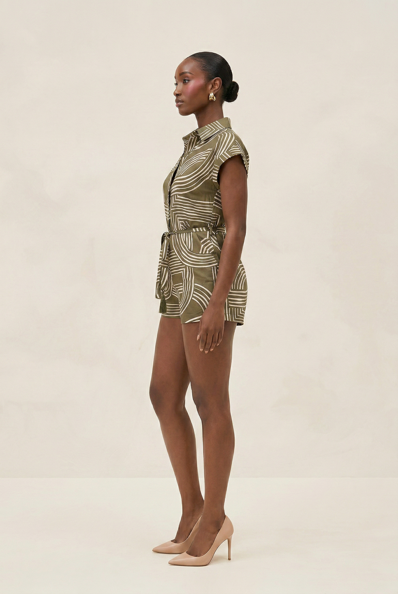 Woman wearing a patterned dress on a beige background