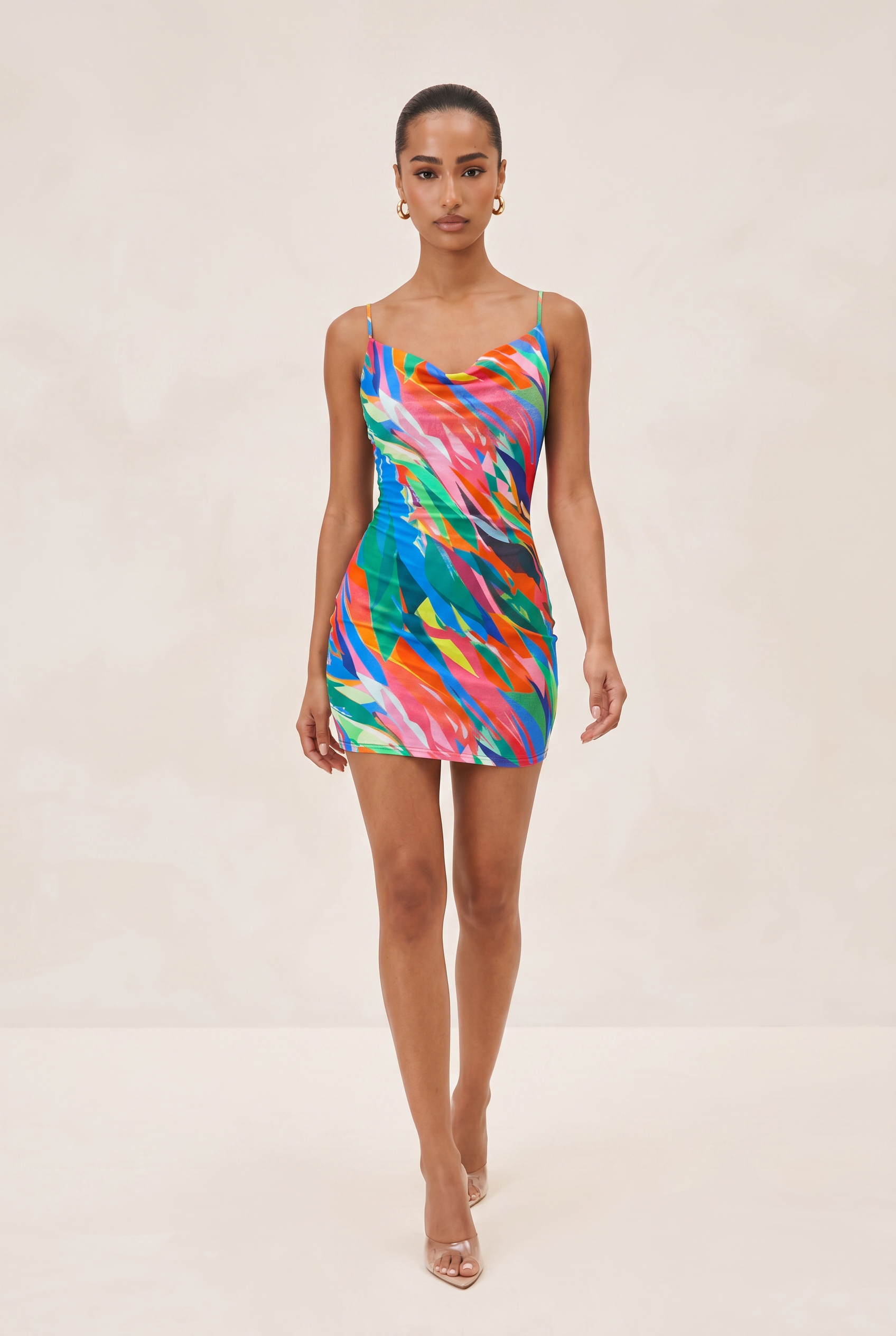 Model wearing a colorful dress on a beige background