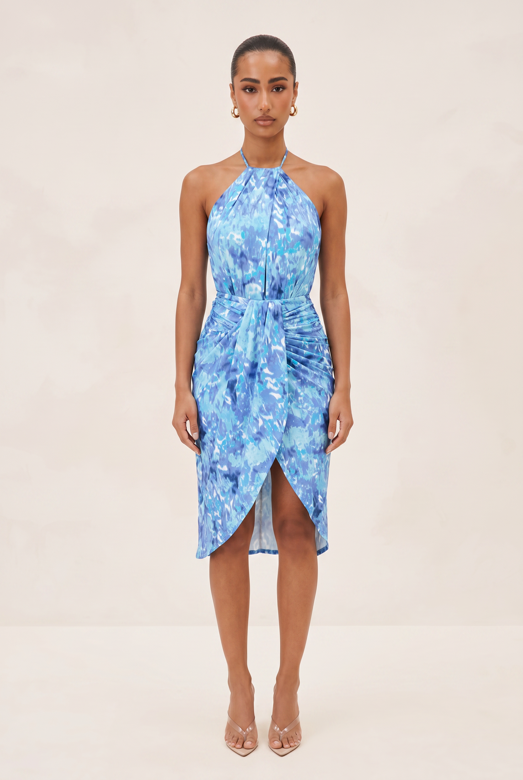 Woman wearing a blue floral dress on a beige background