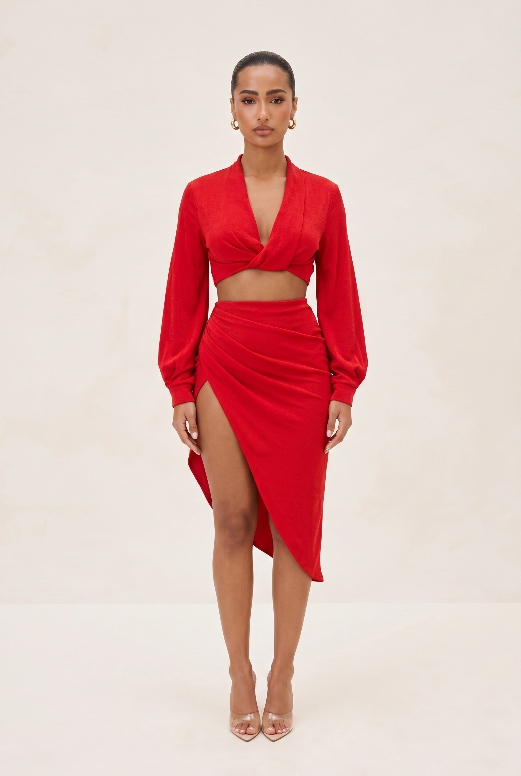 Woman wearing a red outfit with a beige background