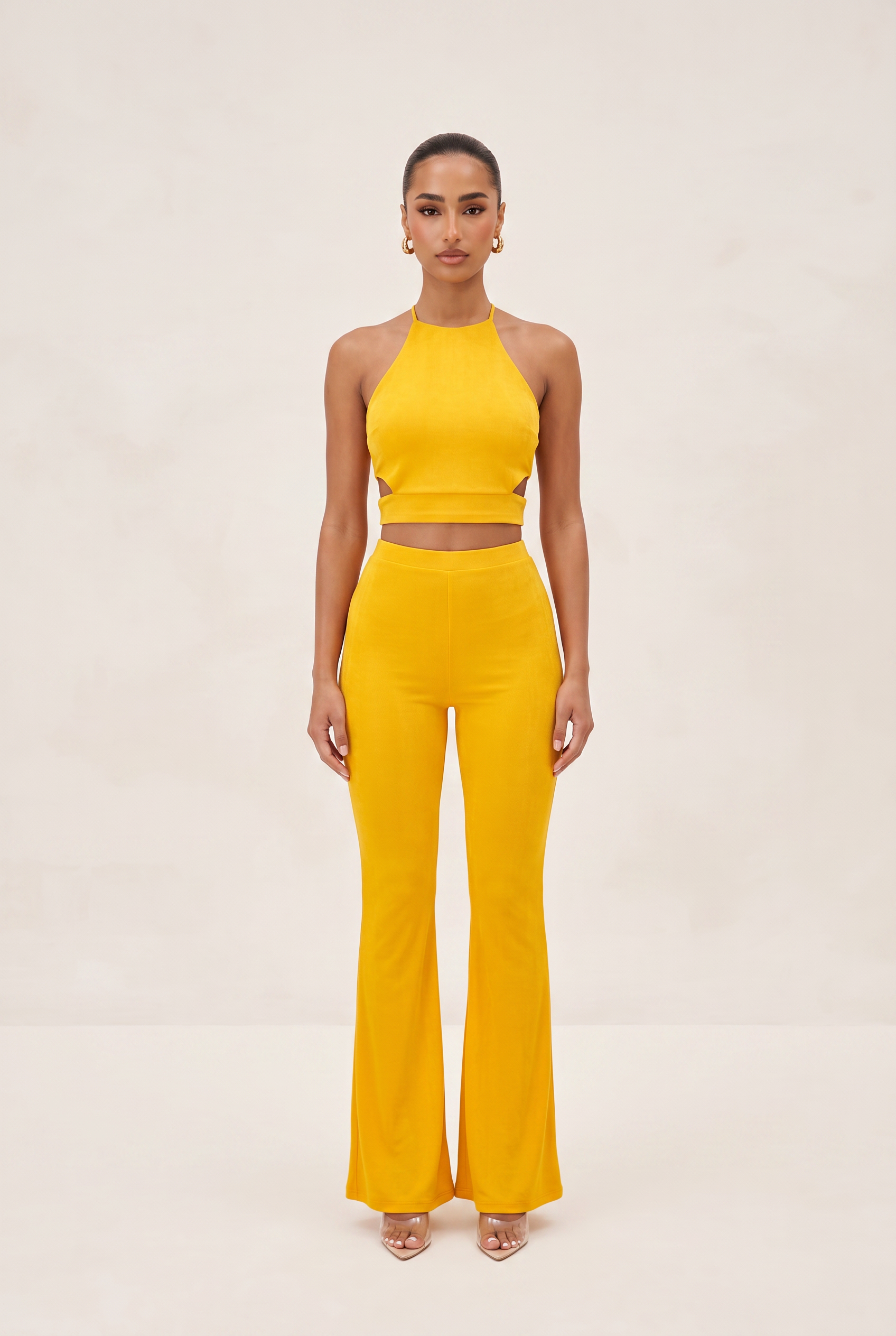 Woman wearing a yellow outfit on a beige background