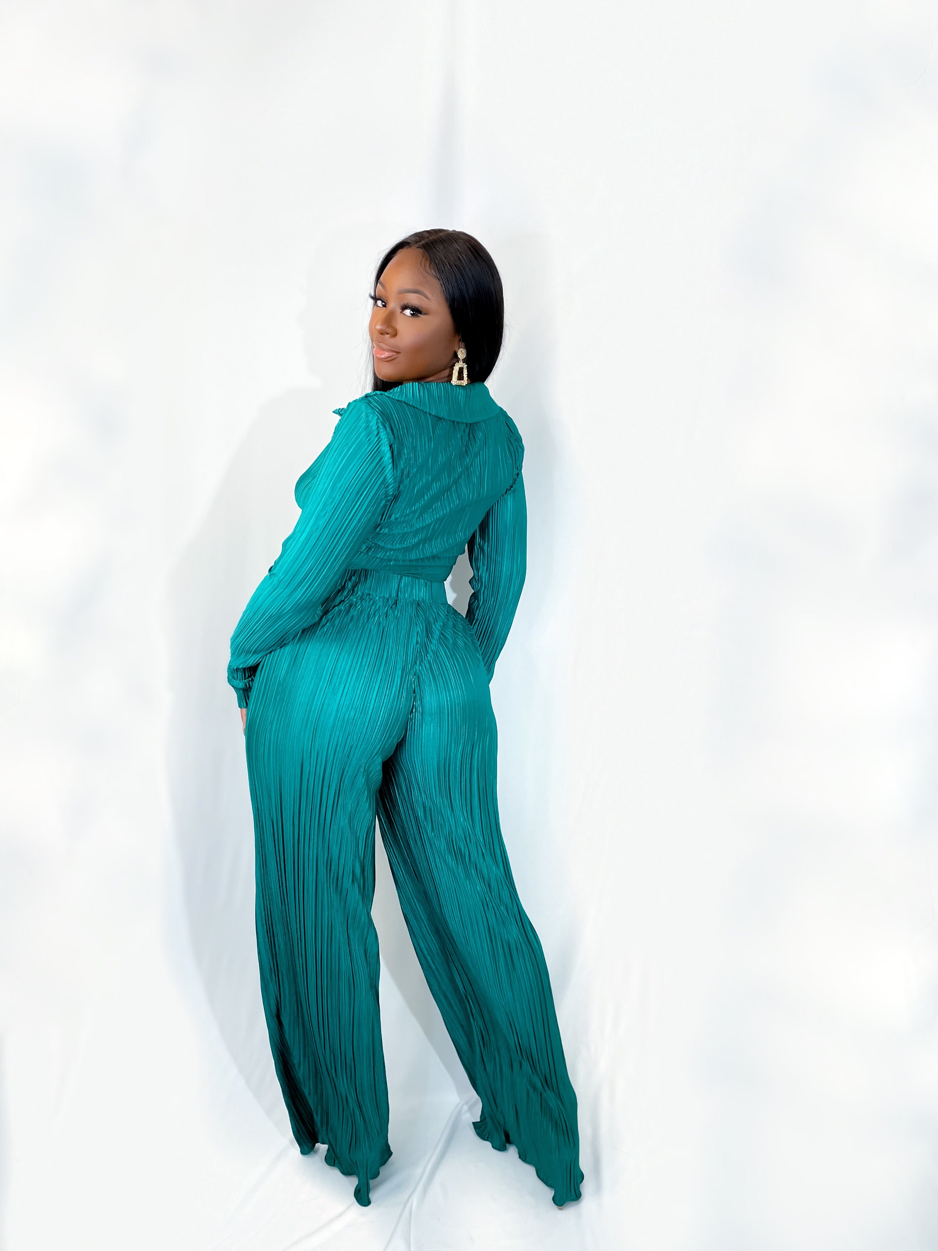 You will be the center of attention in this beautiful casual Living Over The Top Pants Set (Green). The pleated front tie crop top and high-waisted pants set are perfect for dinner, a girl's night out, or a special occasion and is guaranteed to get you noticed. Coming in a shiny emerald green color, it features a straight hem, long sleeves, and an elastic band on the waist giving you a refined look no matter where you may be.